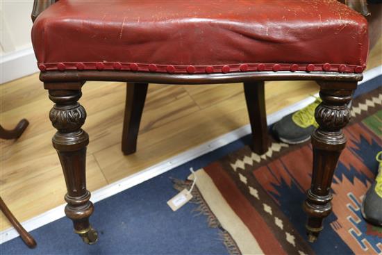 A Victorian red leather elbow chair